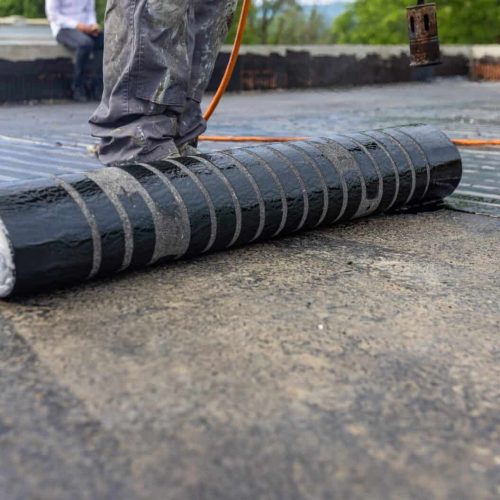 Bituminous membrane waterproofing system details and installation on flat rooftop.